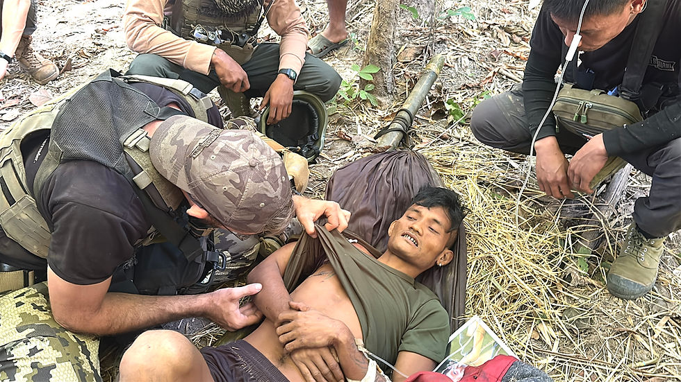 Rangers administer medical aid to a young Burma Army soldier. 
