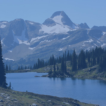 Monashee Moutains in the distance with white text saying Financial Modeling over top