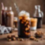 Passion Infused Eatery's dairy-free Iced Coffee served in a glass with large ice cubes and a metal straw, accompanied by an edible straw. In the background, jars of chocolate sauce, vanilla sauce, and caramel sauce offer options for adding flavor to the coffee. A refreshing and customizable beverage perfect for any time of day. 