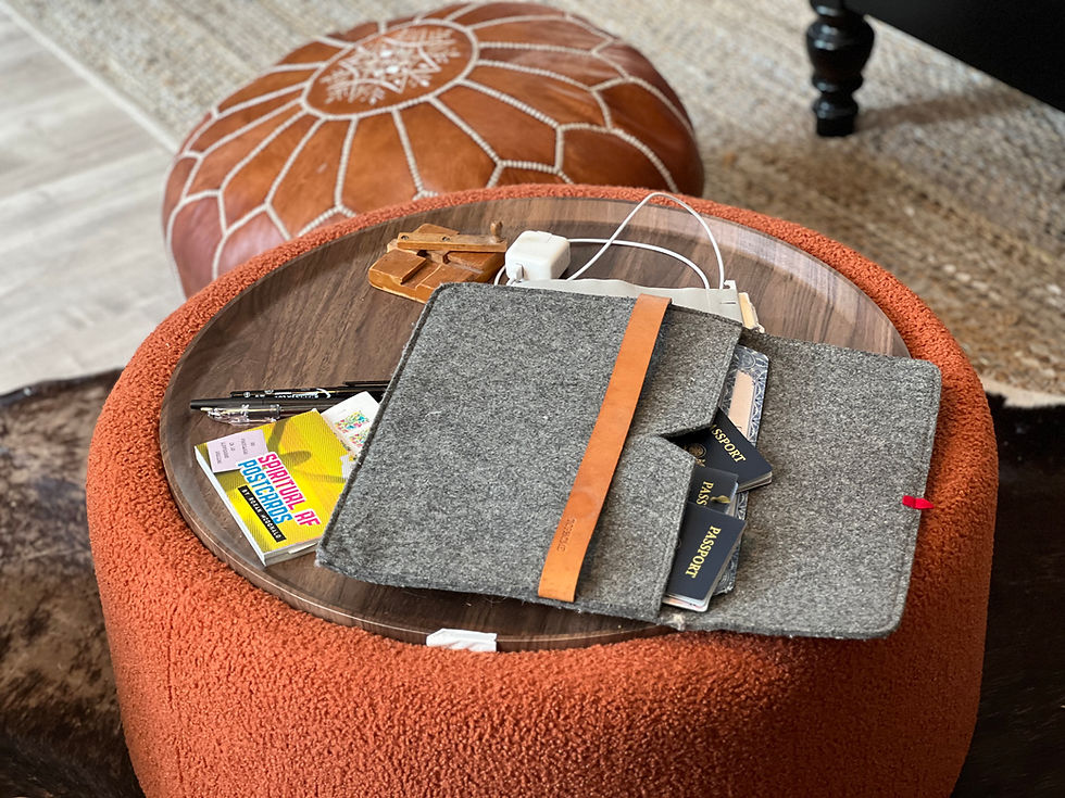 Two US passports, a birth certificate, and travel documents laid out on a wood tray before an international trip