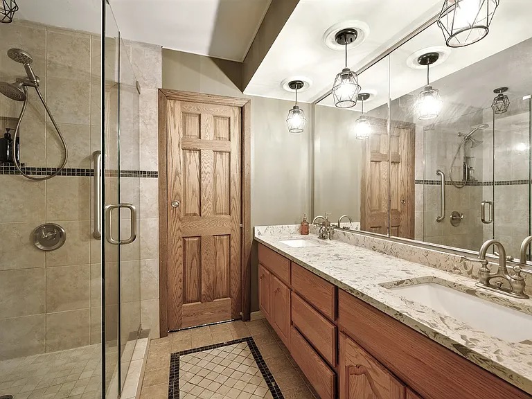Bathroom with glass shower and double vanity