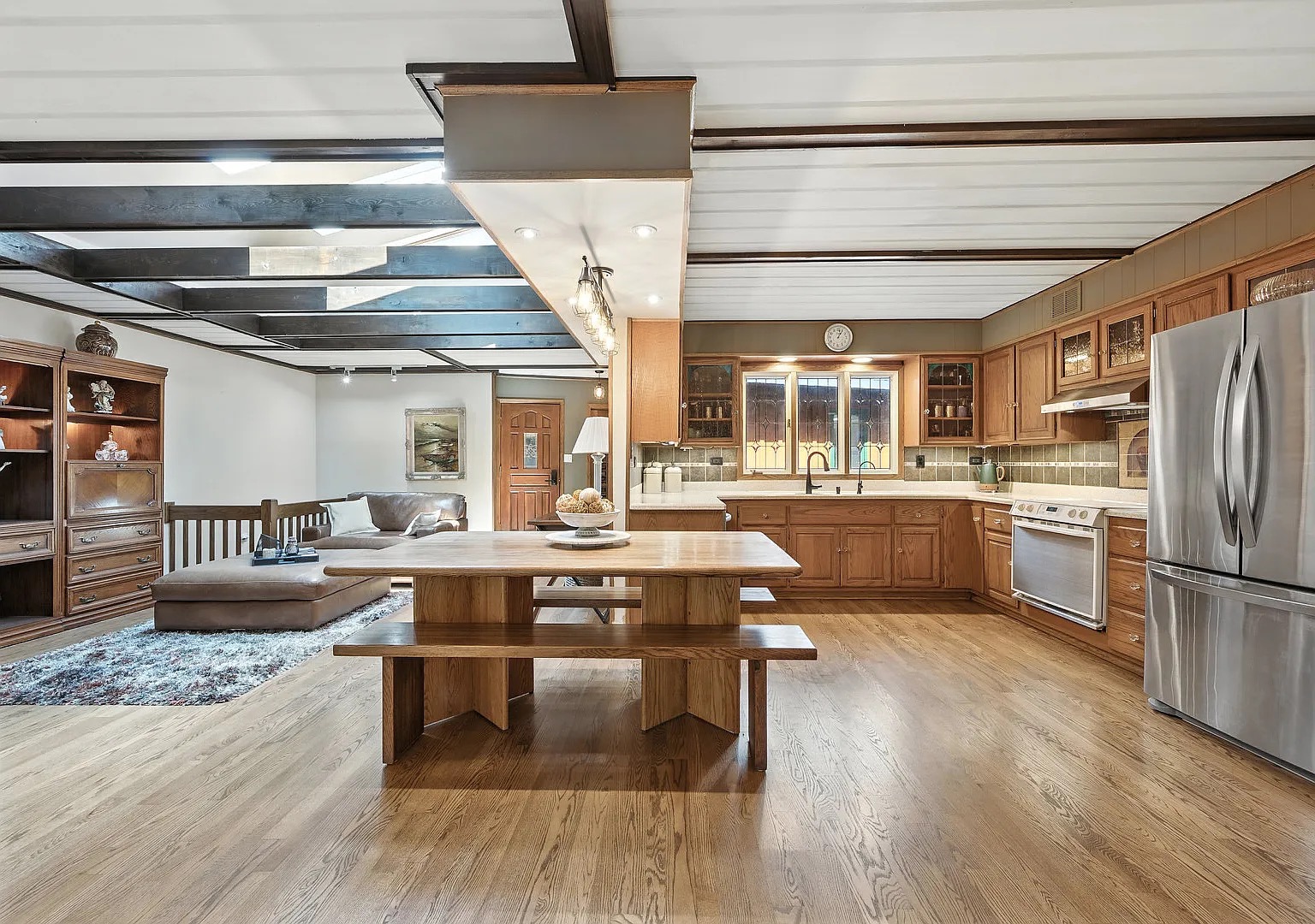 Open kitchen and living area with exposed beams