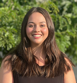 Meghan Rockwood has long dark brown hair and brown eyes. She is wearing a black sleeveless top.