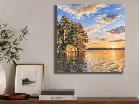 Almost Heaven – original Canadian landscape oil painting of a peaceful sunrise over a calm lake with glowing trees and shoreline rocks.