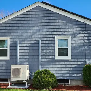 Oceanside blue shake vinyl siding with white J-less window trim install on home in Johnston, Rhode Island.