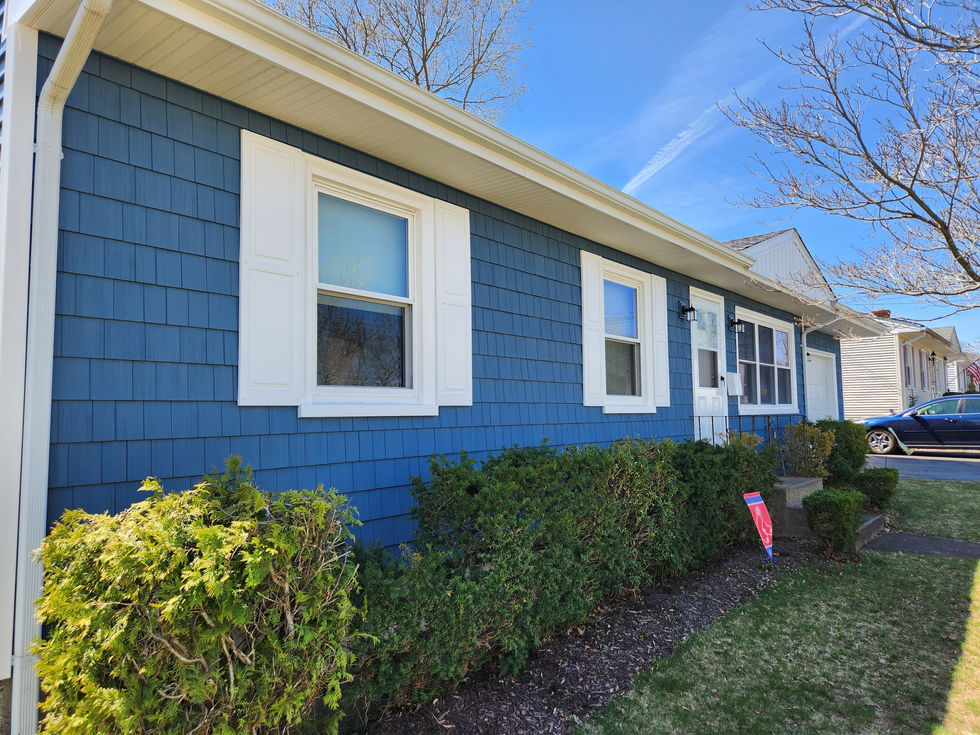 Regatta Blue vinyl shingles installed on front elevation of Coventry RI home.