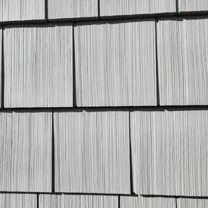 Close-up view of Portsmouth Shake & Shingle Double 7" vinyl siding in Greystone installed on a home in Smithfield, Rhode Island.
