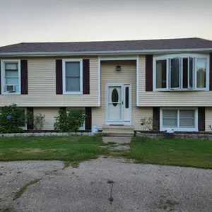 West Warwick home after vinyl siding installation with Maple Odyssey .044" clapboard and burgundy shutters.