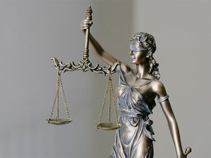 Statue of figure holding scales of justice