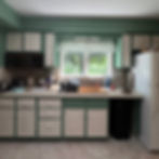 Original outdated 1980s green kitchen before renovation, showing the layout and finishes prior to the full gut remodel.