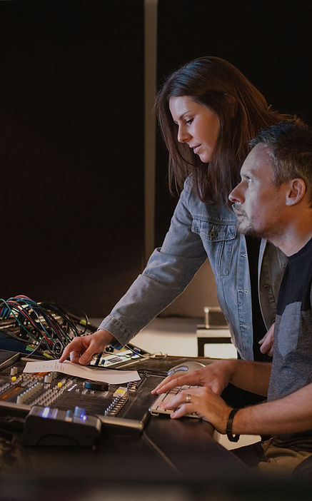 Sean and Anelda working on a song at the console.