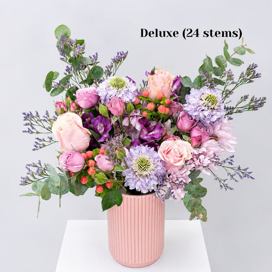 Amethyst Lady purple & pink flower bouquet arranged in a ceramic vase