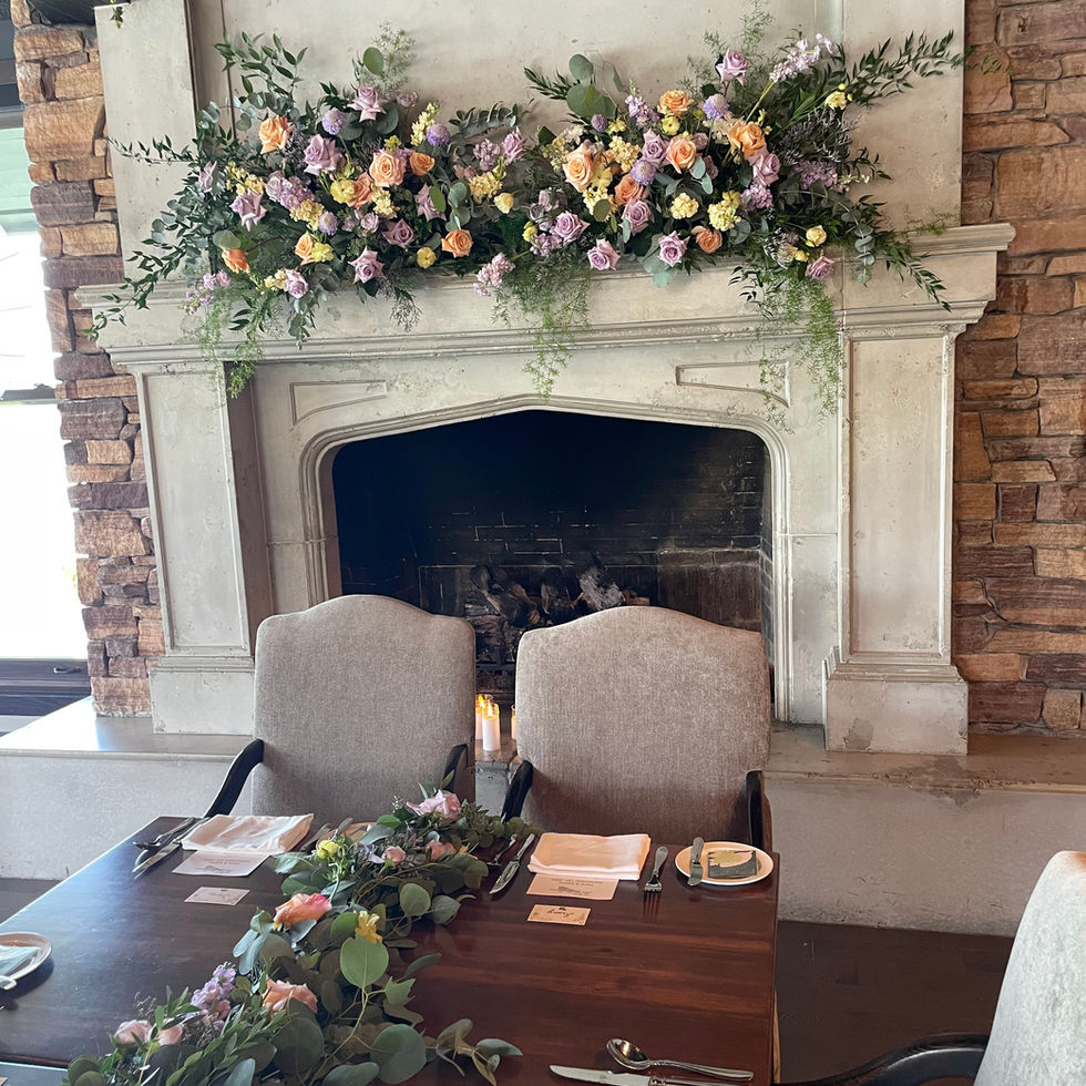 Romantic wedding table setting with floral fireplace mantel