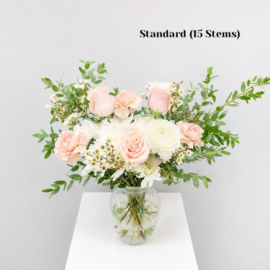 Blush Whisper pink & white flower bouquet arranged in a clear glass vase