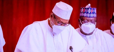 Buhari signs 3 bills into law against money laundering, others