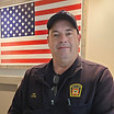 Firefighter in uniform in front of American flag