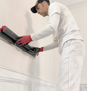Arnaud Fouassier preparing the wall for wallpapering