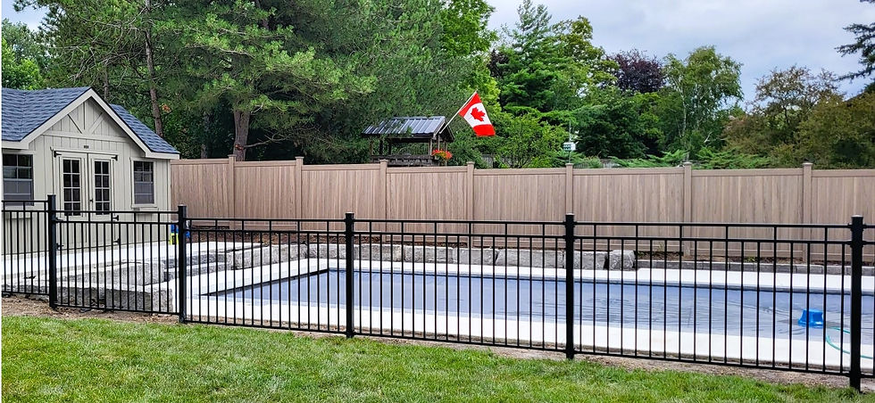 Pool with black metal and wood fences, Canadian flag