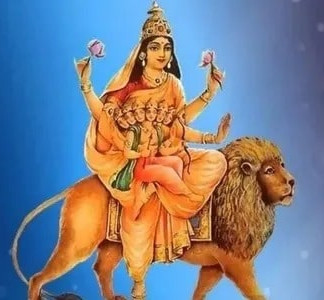 Goddess Durga sitting on a lion, holding lotus flowers, and a blue background.