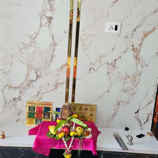 Hindu deity altar with offerings; Ganga Dussehra puja; beautiful marble wall.