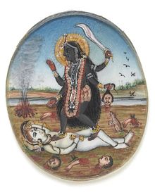 Kali, the fierce Hindu goddess, stands with a sword over a figure.