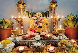 Lakshmi idol with Diwali Lakshmi Pujan दिवाळी लक्ष्मी पूजन, candles, flower decor, festive background.
