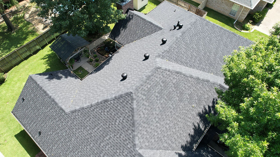 High angle view of a roofing crew installing new asphalt shingles