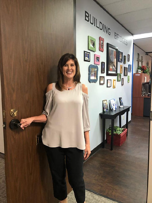 Teresa at entrance of Bridge Builder Academy in DFW