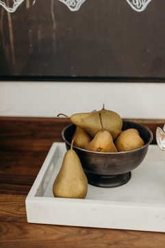 pears in a metal bowl inside a tray