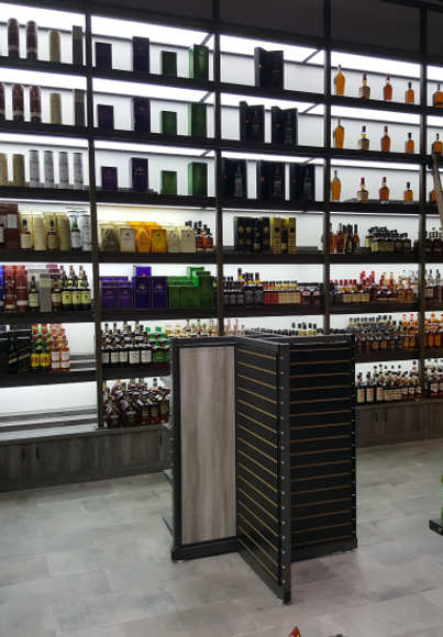 custom liquor retail store/ high end liquor store equipt with backlid shelving and modular cabinets