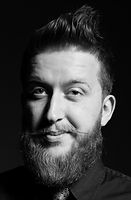 Younger man with mustache and beard