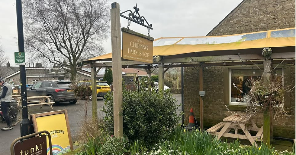 High angle view of a cyclist enjoying a coffee break at Chipping Farm Shop outdoor seating