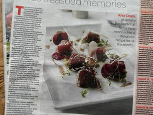 Newspaper page titled Cambridge Independent, featuring a fish dish recipe with text about tuna sashimi. Emphasizes culinary traditions.