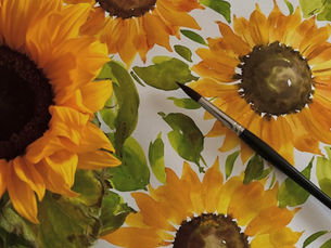 Sunflowers painted on a canvas with a brush