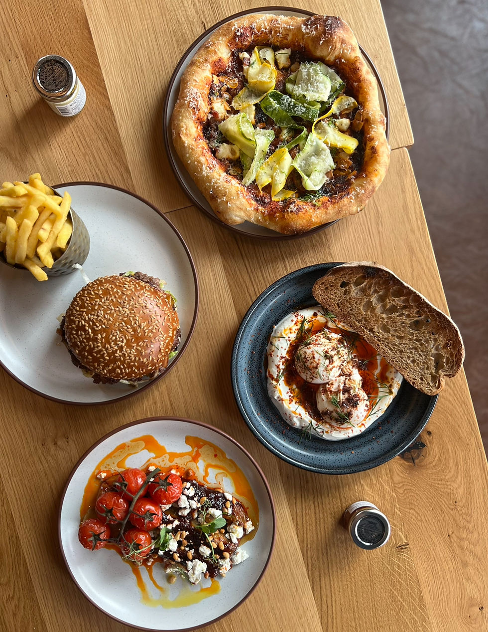 Beef burger and fries, baked aubergine with harissa and roasted tomatoes, Turkish eggs with yoghurt and sourdough bread, garlic bread
