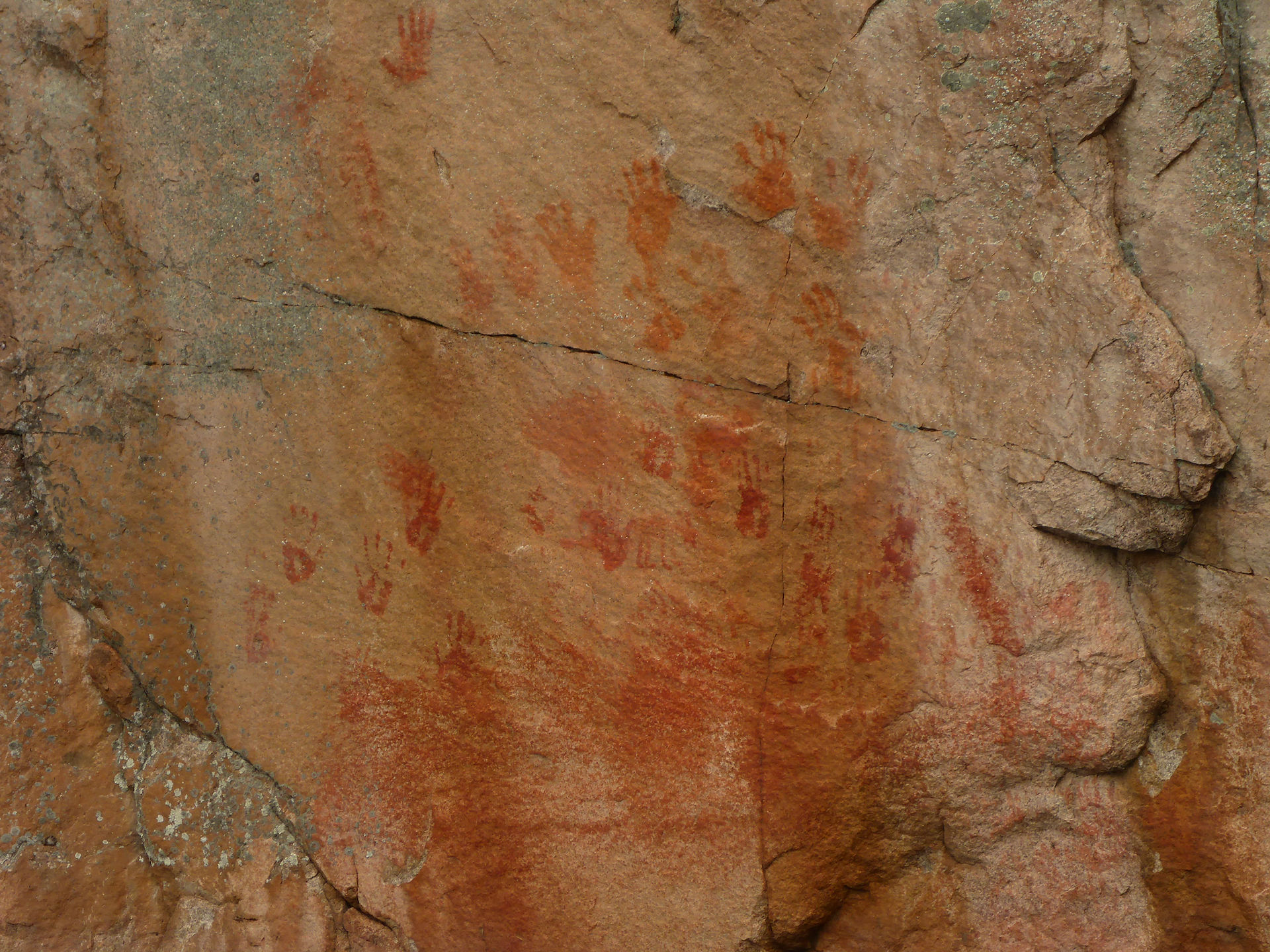 A wall with hands prints