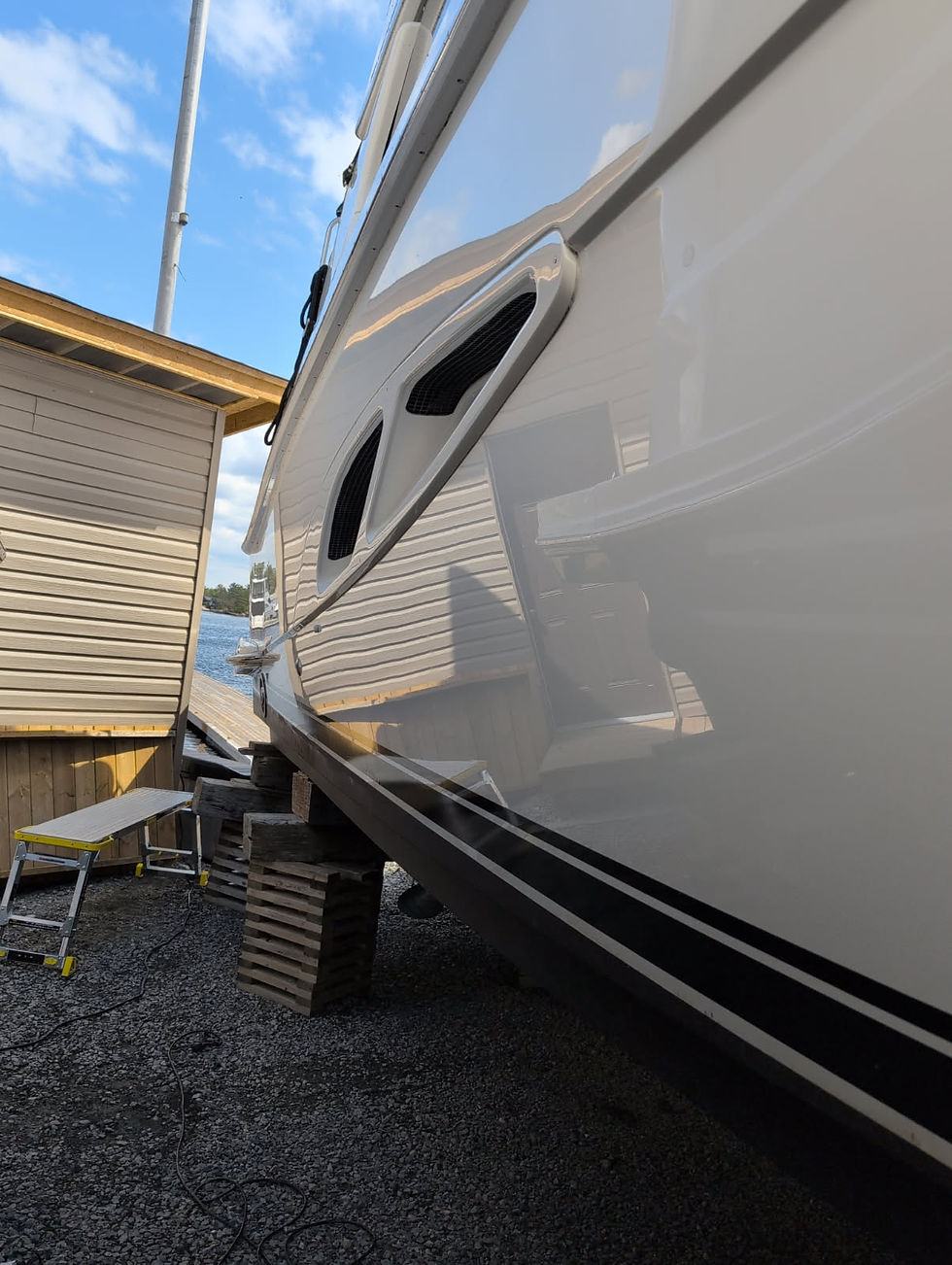 Close-up view of a freshly graphene nano coated motorboat hull reflecting its surroundings