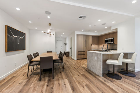 Wide view of the open floor plan, highlighting the flow from the dining area into the integrated kitchen space.