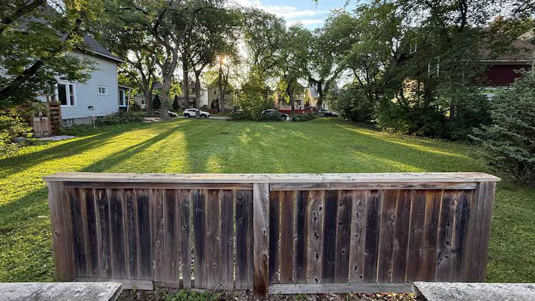The disputed greenspace on Sherburn Street. With a few park benches and a grove of trees it could be great place to play and cool off on hot summer days.
