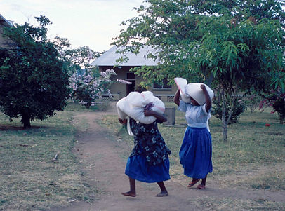 Sisters Carrying Sacks on Head
