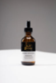 A bottle of the Key 2 Beauty Natural Growth Oil.