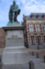 A statue of a 16th century Dutchman wearing the finery of a statesman. The statue is on a plinth with the inscription, "Graaf Jan Van Nassau."
