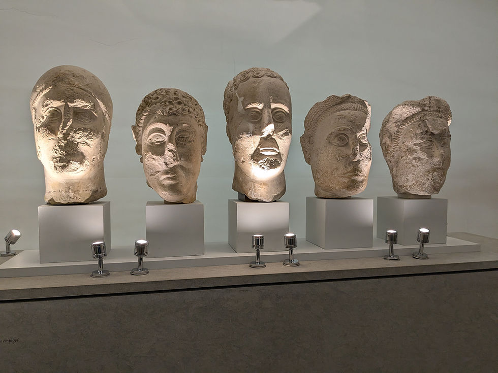 A row of five sculpted stone heads.