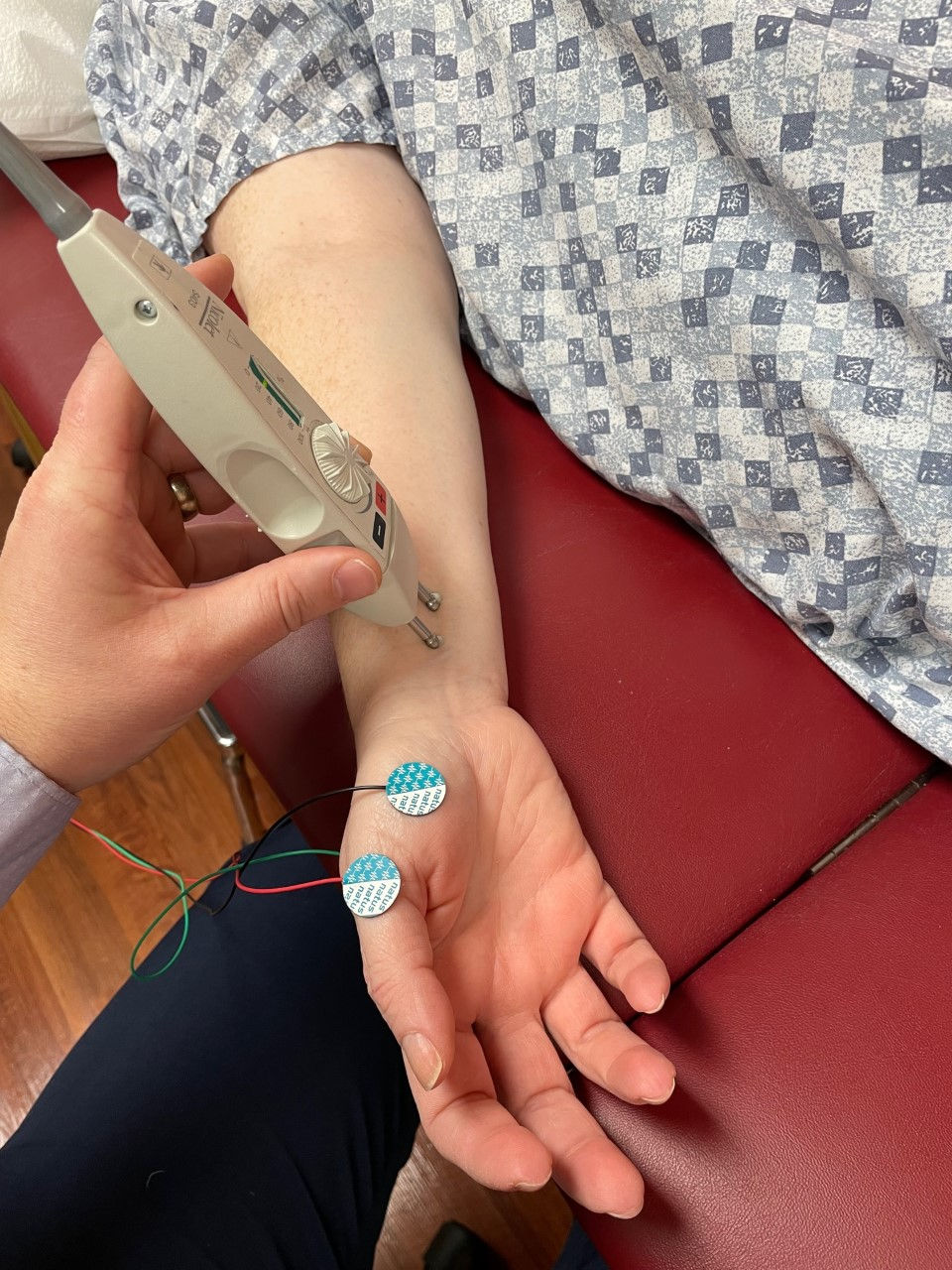 Nerve conduction testing being done on a wrist