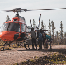 When should a helicopter be used to evacuate an injured worker?