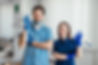photo-smiling-dentist-standing-with-arms-crossed-with-her-colleague-showing-okay-sign.jpg