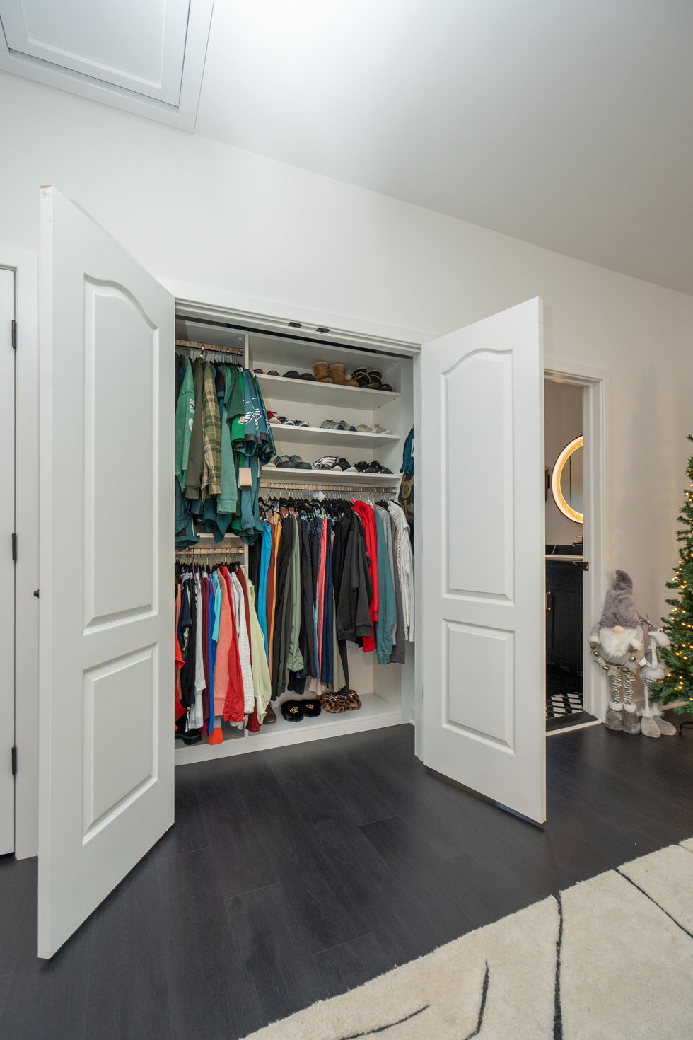 Custom closet with clothes inside; stylish interior spaces, modern home interior design.