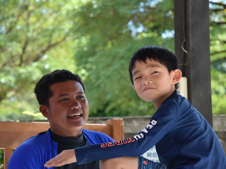 Surf Instructor teaching kid