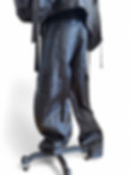 Black tailored couture trousers displayed on mannequin in studio.