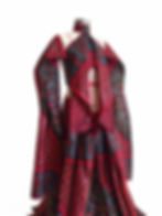 Red patterned avant-garde couture top with sleeves with extended panels displayed in studio.